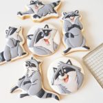 These cookies feature Meeko, the racoon from Pocahontas, in various poses